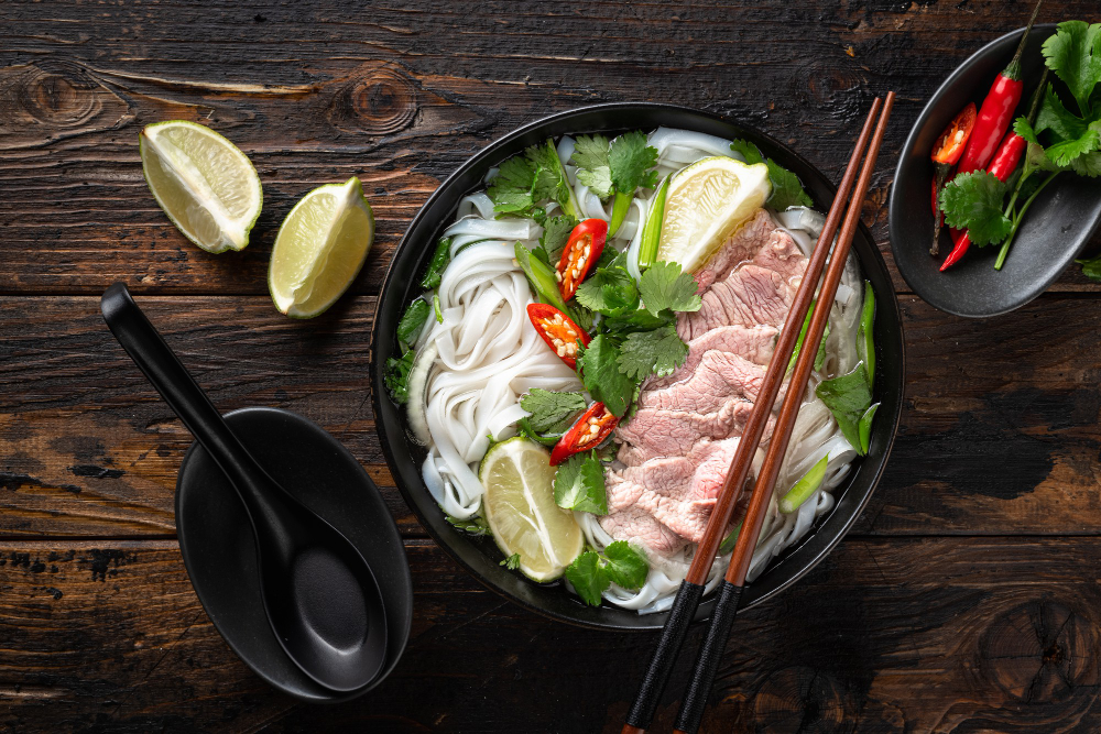 pho-bo-vietnamese-soup-with-beef-noodles-wooden-background-top-view